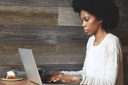 Woman on laptop in cafe
