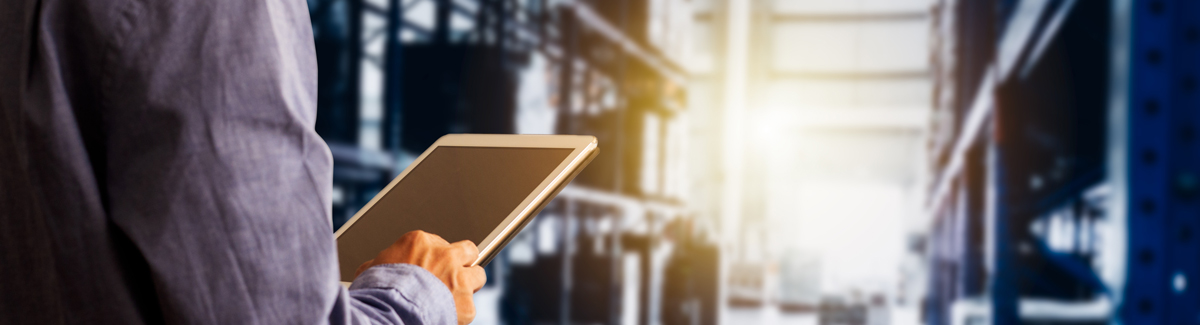 Man looking at stock control on ipad