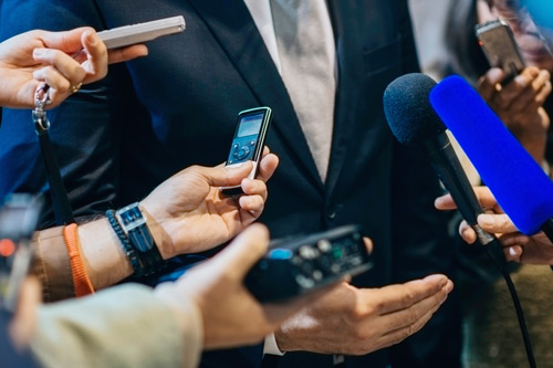 Man being interviewed by the press