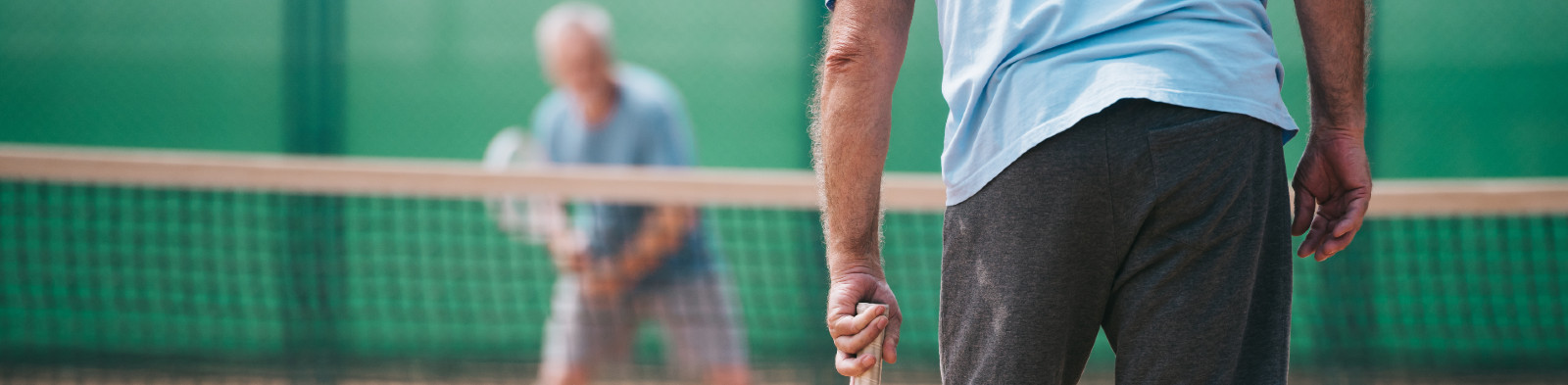 Elderly gentlemen playing tennis