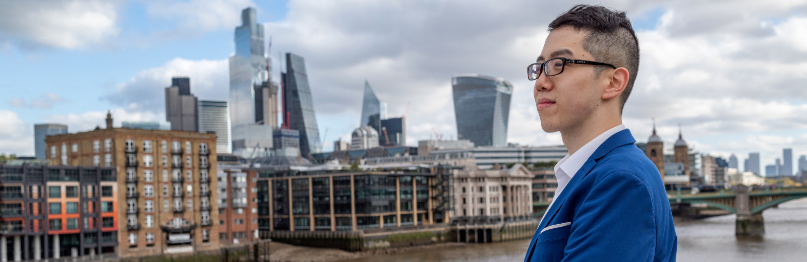 A student pictured in front of skyscrapers 