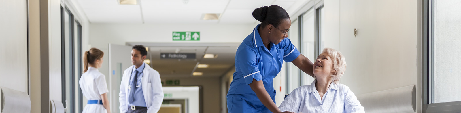 Nurse and patient in hospital corridor