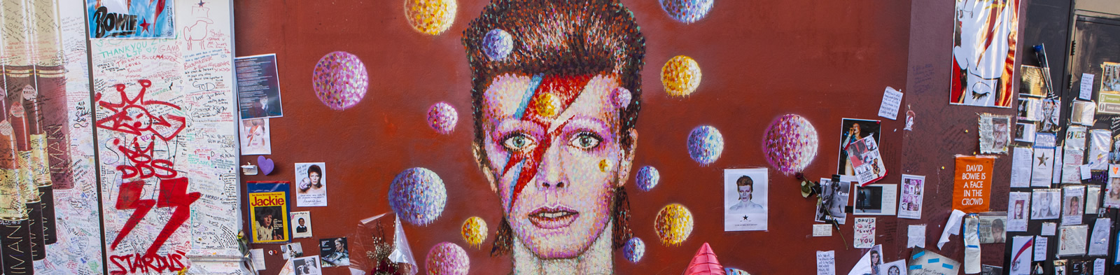 A David Bowie mural surrounded by flowers