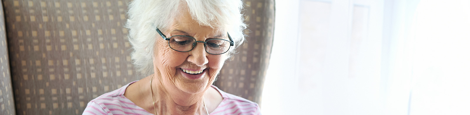 Senior citizen looking at an electronic tablet