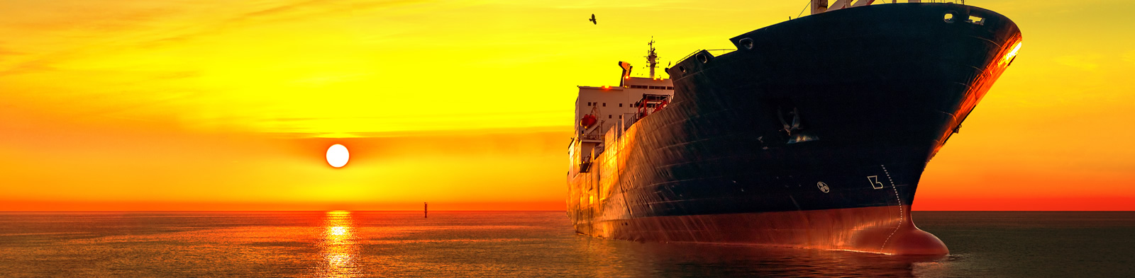 Oil tanker sailing at sunset